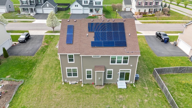 153 N Bend Way, Elgin, IL 60124 - rear view of property with a residential view, solar panels, a fenced backyard, and roof with shingles