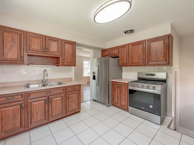 2408 Nathaniel Pl, Evanston, IL 60202 - kitchen with appliances with stainless steel finishes, light countertops, brown cabinetry, and backsplash