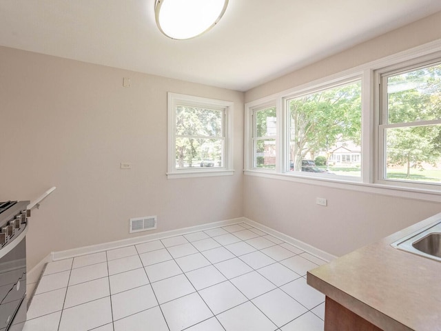 2408 Nathaniel Pl, Evanston, IL 60202 - unfurnished dining area featuring plenty of natural light and light tile patterned floors