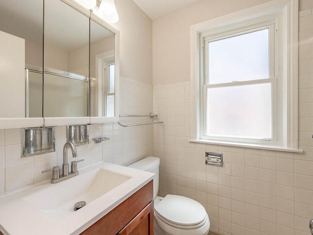 2408 Nathaniel Pl, Evanston, IL 60202 - bathroom with vanity, a shower with door, and tile walls