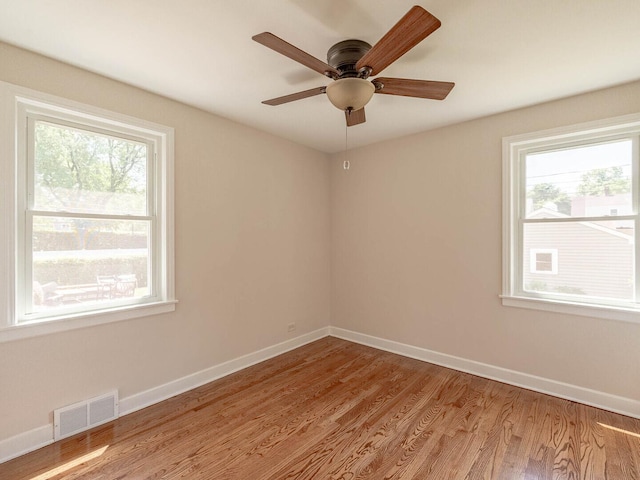 2408 Nathaniel Pl, Evanston, IL 60202 - empty room with plenty of natural light, wood finished floors, and a ceiling fan