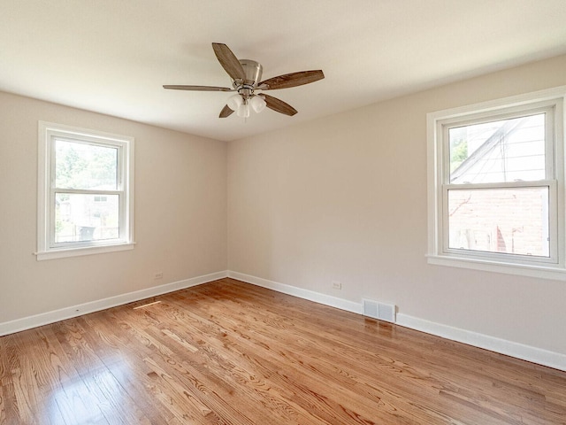 2408 Nathaniel Pl, Evanston, IL 60202 - spare room with healthy amount of natural light, light wood-type flooring, and a ceiling fan