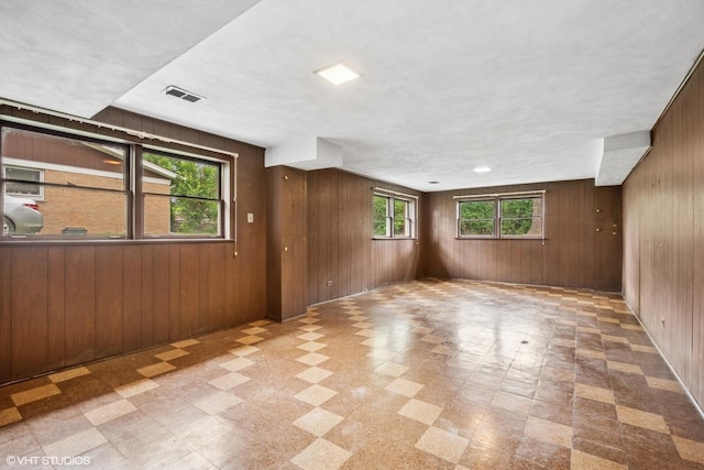 217 Heather Ln, Wilmette, IL 60091 - empty room with tile patterned floors and wood walls