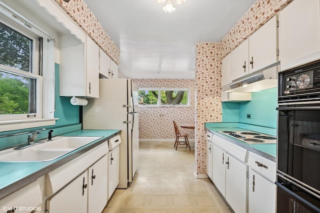 217 Heather Ln, Wilmette, IL 60091 - kitchen featuring white appliances, light flooring, white cabinetry, under cabinet range hood, and wallpapered walls