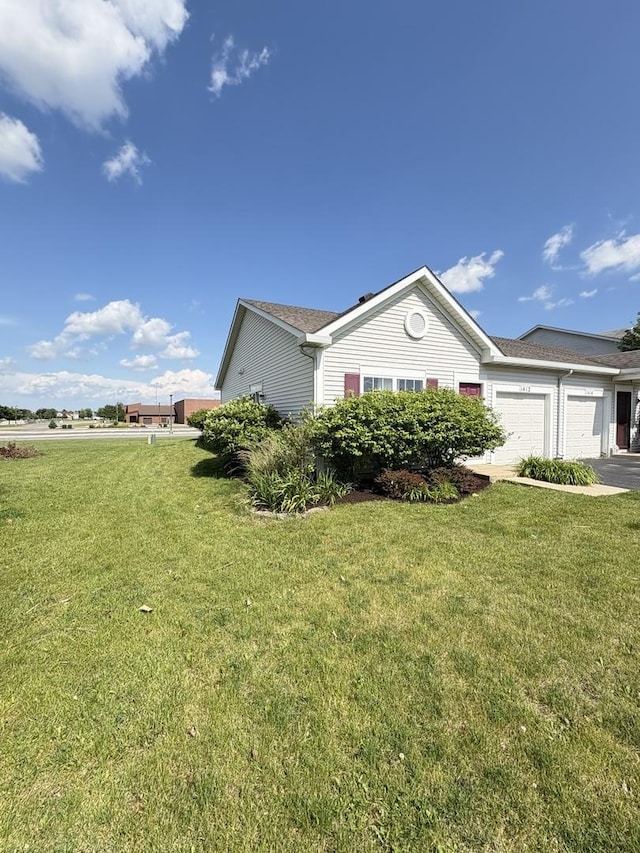 1412 Sherborn Ct, Minooka, IL 60447 - view of side of property featuring an attached garage, a lawn, and driveway