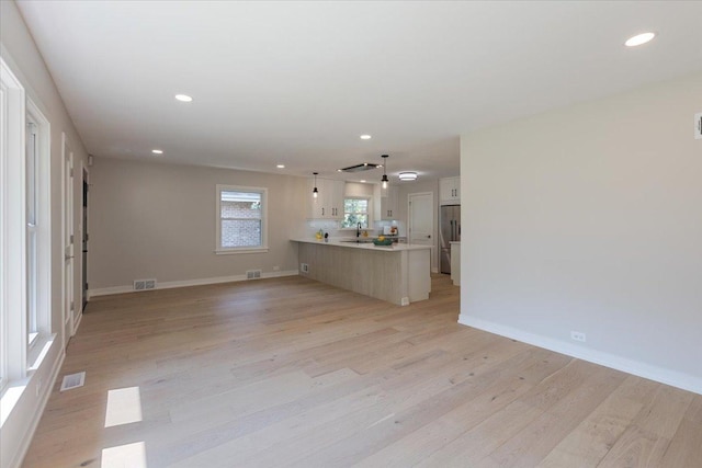 7418 Kildare Ave, Skokie, IL 60076 - unfurnished living room with light wood-style flooring and recessed lighting