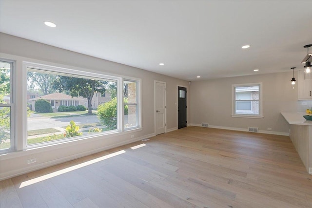 7418 Kildare Ave, Skokie, IL 60076 - unfurnished living room with light wood-type flooring and recessed lighting