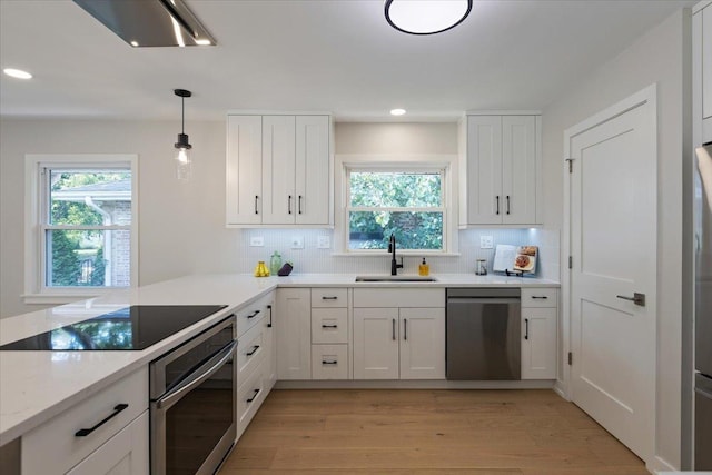 7418 Kildare Ave, Skokie, IL 60076 - kitchen featuring stainless steel appliances, healthy amount of natural light, tasteful backsplash, white cabinetry, and recessed lighting