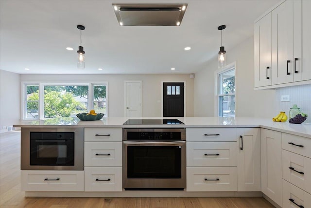 7418 Kildare Ave, Skokie, IL 60076 - kitchen with black appliances, healthy amount of natural light, light countertops, white cabinetry, and recessed lighting