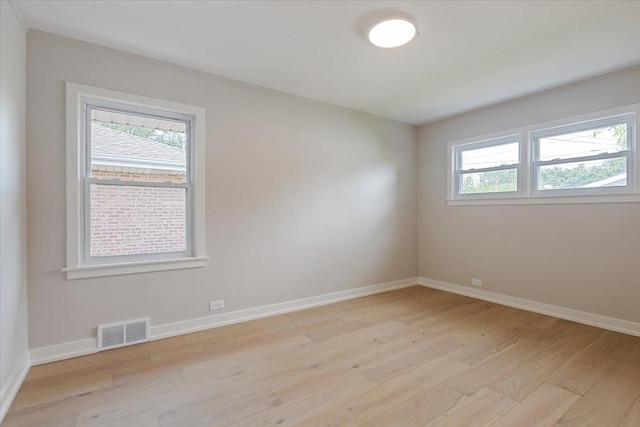 7418 Kildare Ave, Skokie, IL 60076 - empty room with light wood-style flooring and healthy amount of natural light