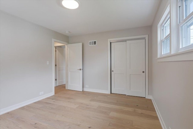 7418 Kildare Ave, Skokie, IL 60076 - unfurnished bedroom with light wood-style floors and a closet