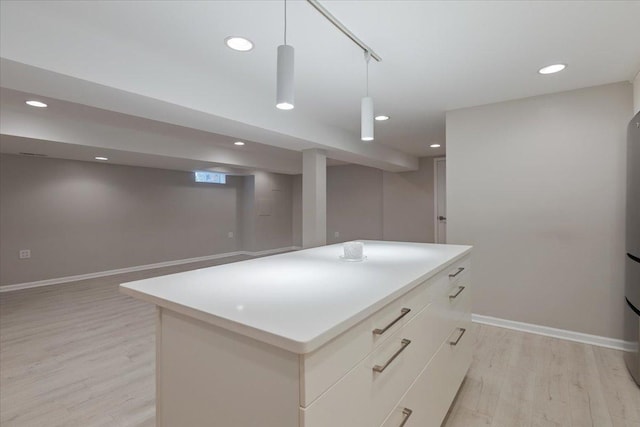 7418 Kildare Ave, Skokie, IL 60076 - kitchen with light wood-type flooring, recessed lighting, a kitchen island, light countertops, and modern cabinets
