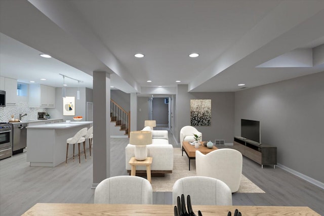 7418 Kildare Ave, Skokie, IL 60076 - living room with light wood-style flooring, recessed lighting, and stairs
