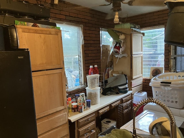 1403 Barberry Ln, Round Lake Beach, IL 60073 - kitchen featuring light countertops, brick wall, and a ceiling fan