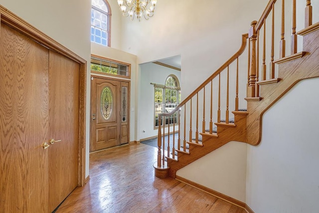2504 Monterey Dr, Plainfield, IL 60586 - entryway with a high ceiling, a chandelier, stairs, and wood finished floors