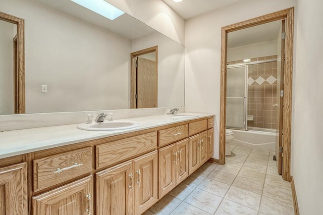 2504 Monterey Dr, Plainfield, IL 60586 - full bathroom featuring double vanity, tile patterned flooring, a skylight, and combined bath / shower with glass door