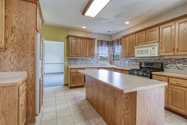 2504 Monterey Dr, Plainfield, IL 60586 - kitchen with white appliances, light countertops, tasteful backsplash, a center island, and recessed lighting
