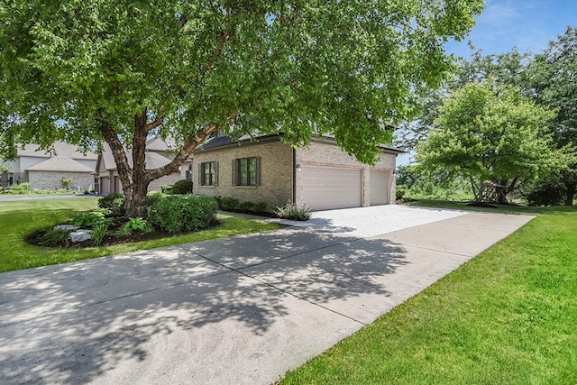 2504 Monterey Dr, Plainfield, IL 60586 - view of front facade featuring concrete driveway, a front yard, a garage, and brick siding