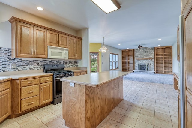 2504 Monterey Dr, Plainfield, IL 60586 - kitchen featuring white microwave, stainless steel gas range, light tile patterned floors, light countertops, and recessed lighting