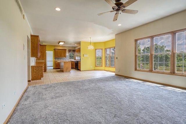 2504 Monterey Dr, Plainfield, IL 60586 - kitchen featuring open floor plan, brown cabinets, light colored carpet, a ceiling fan, and recessed lighting