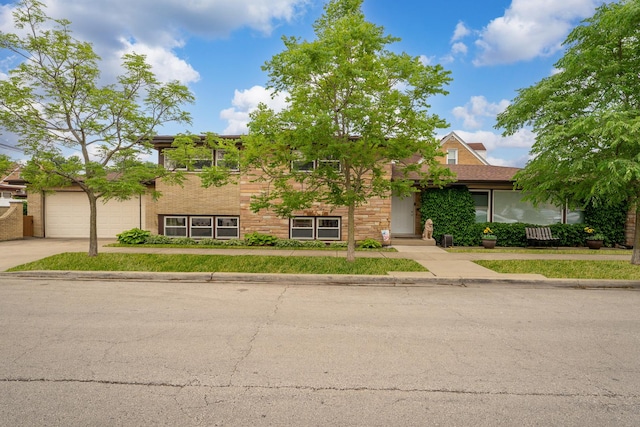 3257 N Nottingham Ave, Chicago, IL 60634 - view of property hidden behind natural elements with concrete driveway and an attached garage