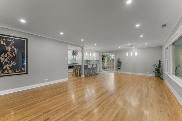 3257 N Nottingham Ave, Chicago, IL 60634 - unfurnished living room featuring recessed lighting, ornamental molding, and light wood-type flooring