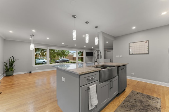 3257 N Nottingham Ave, Chicago, IL 60634 - kitchen with stainless steel dishwasher, gray cabinetry, light stone counters, a kitchen island with sink, and hanging light fixtures