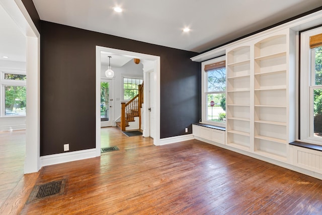 1123 Linden Ave, Wilmette, IL 60091 - empty room featuring wood finished floors, stairway, and built in features