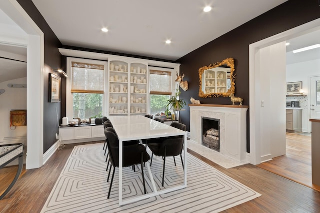 1123 Linden Ave, Wilmette, IL 60091 - dining area featuring wood finished floors, a high end fireplace, plenty of natural light, and recessed lighting