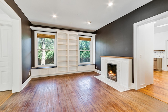 1123 Linden Ave, Wilmette, IL 60091 - unfurnished living room with wood-type flooring, a high end fireplace, and plenty of natural light
