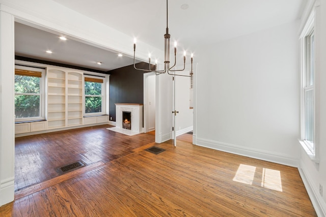 1123 Linden Ave, Wilmette, IL 60091 - unfurnished living room with wood finished floors, a chandelier, a fireplace with flush hearth, and recessed lighting