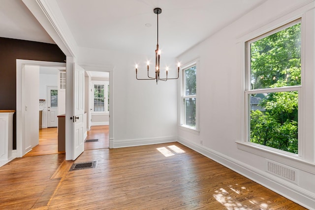 1123 Linden Ave, Wilmette, IL 60091 - unfurnished dining area with a chandelier and light wood-type flooring