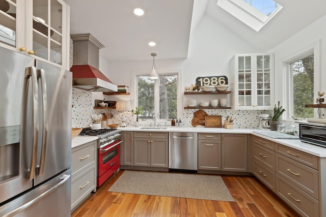 1123 Linden Ave, Wilmette, IL 60091 - kitchen featuring stainless steel appliances, open shelves, extractor fan, a skylight, and recessed lighting