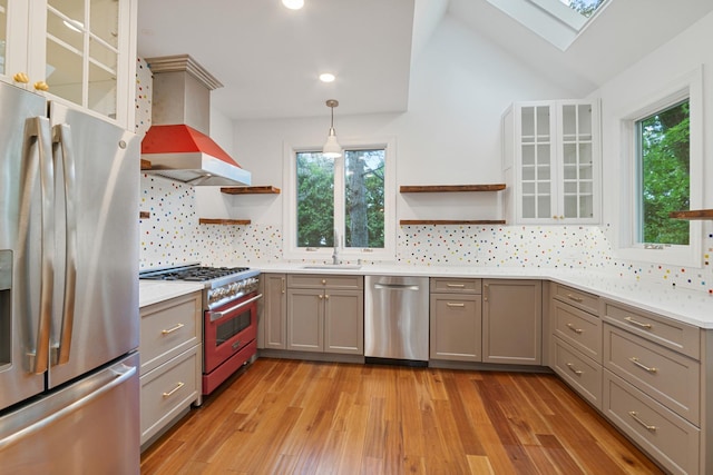 1123 Linden Ave, Wilmette, IL 60091 - kitchen featuring stainless steel appliances, open shelves, gray cabinetry, wall chimney range hood, and a skylight