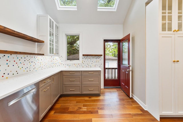 1123 Linden Ave, Wilmette, IL 60091 - kitchen with stainless steel dishwasher, a skylight, open shelves, gray cabinets, and light wood-style flooring