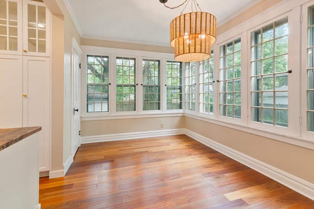 1123 Linden Ave, Wilmette, IL 60091 - unfurnished sunroom with a chandelier, crown molding, plenty of natural light, and wood finished floors