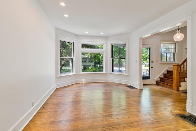 1123 Linden Ave, Wilmette, IL 60091 - empty room with hardwood / wood-style flooring, stairway, and recessed lighting