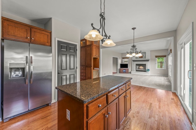 24006 Skyler Ln, Plainfield, IL 60586 - kitchen featuring stainless steel fridge with ice dispenser, light wood-type flooring, a center island, and decorative light fixtures