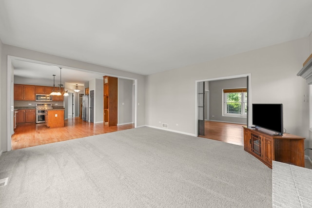 24006 Skyler Ln, Plainfield, IL 60586 - unfurnished living room with light colored carpet and a chandelier