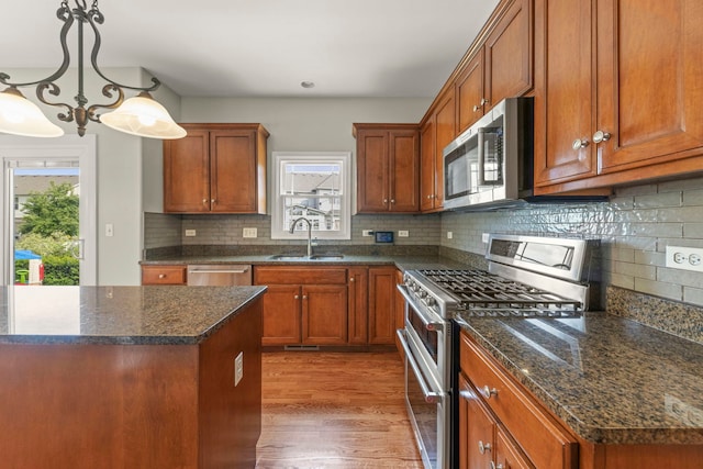 24006 Skyler Ln, Plainfield, IL 60586 - kitchen with appliances with stainless steel finishes, healthy amount of natural light, brown cabinetry, and light wood-style floors