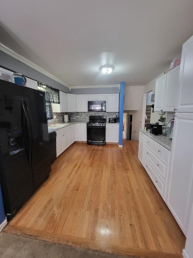 604 Parkshore Dr, Shorewood, IL 60404 - kitchen with black appliances, light countertops, white cabinets, light wood-style floors, and decorative backsplash