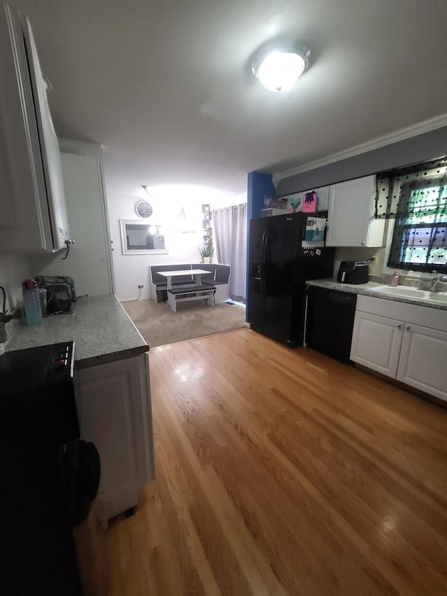 604 Parkshore Dr, Shorewood, IL 60404 - kitchen featuring black appliances, light wood-style flooring, white cabinetry, crown molding, and light countertops