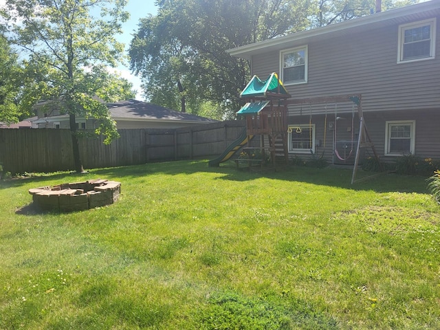 604 Parkshore Dr, Shorewood, IL 60404 - fenced backyard with a fire pit and a playground