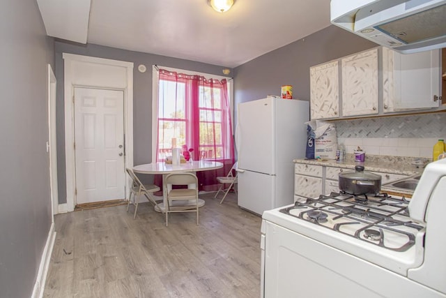 3810 W Ohio St, Chicago, IL 60624 - kitchen with white appliances, extractor fan, light countertops, tasteful backsplash, and light wood-type flooring