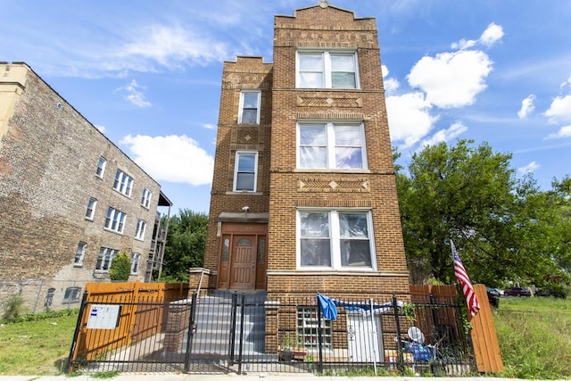 3810 W Ohio St, Chicago, IL 60624 - view of front of house with brick siding, a gate, and a fenced front yard