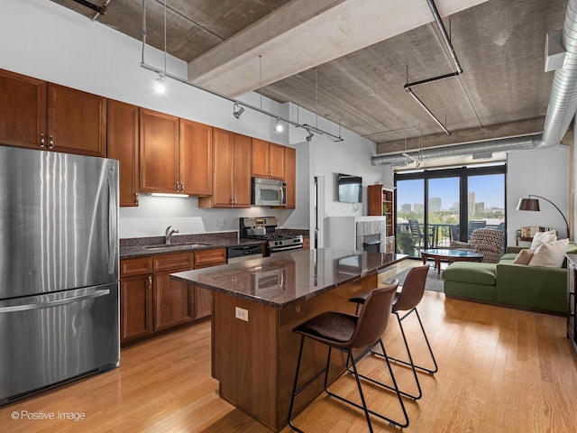 833 W 15th Pl Unit 502, Chicago, IL 60608 - kitchen with stainless steel appliances, track lighting, light wood-type flooring, a center island, and open floor plan
