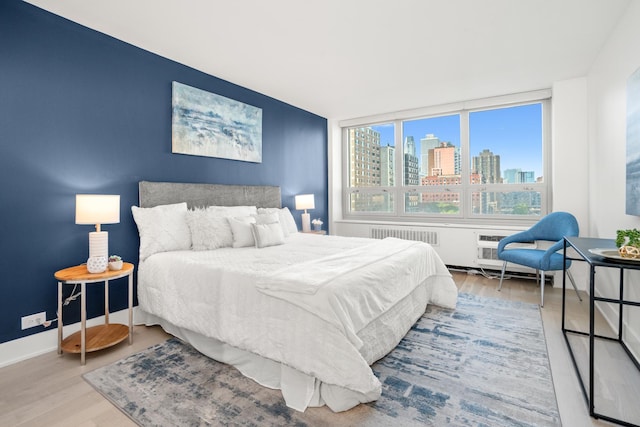 88 W Schiller St Unit 904, Chicago, IL 60610 - bedroom featuring a view of skyline and wood finished floors