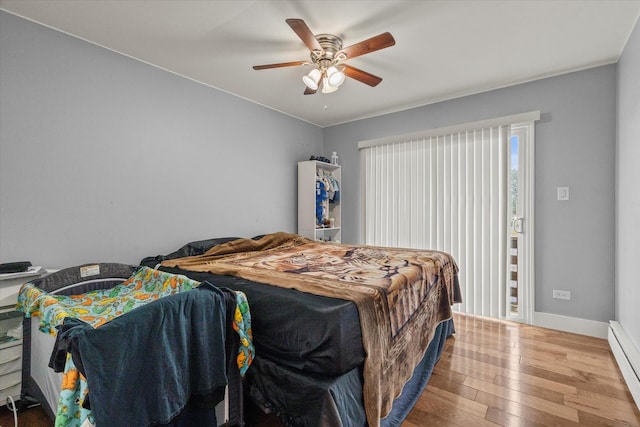 14501 Keystone Ave Unit 8, Midlothian, IL 60445 - bedroom featuring a baseboard heating unit, wood-type flooring, and ceiling fan
