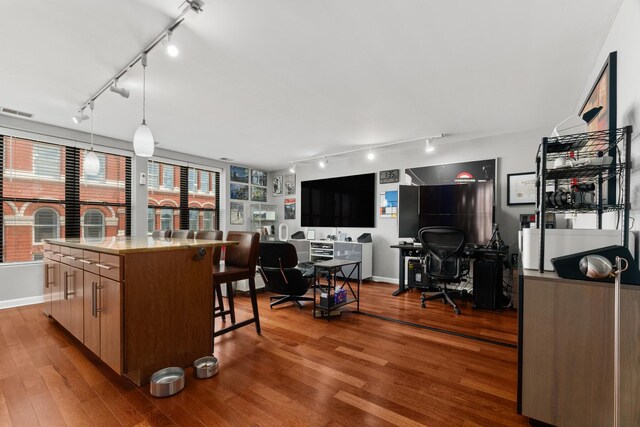 1600 N Halsted St Unit 3C, Chicago, IL 60614 - kitchen featuring track lighting, wood finished floors, a desk, and a center island