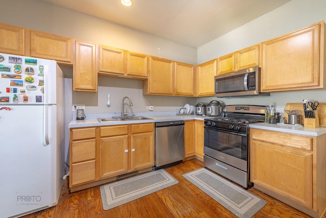 2012 Juniper Ct Unit 2012, Glendale Heights, IL 60139 - kitchen featuring stainless steel appliances, light wood-style flooring, light countertops, and light brown cabinets